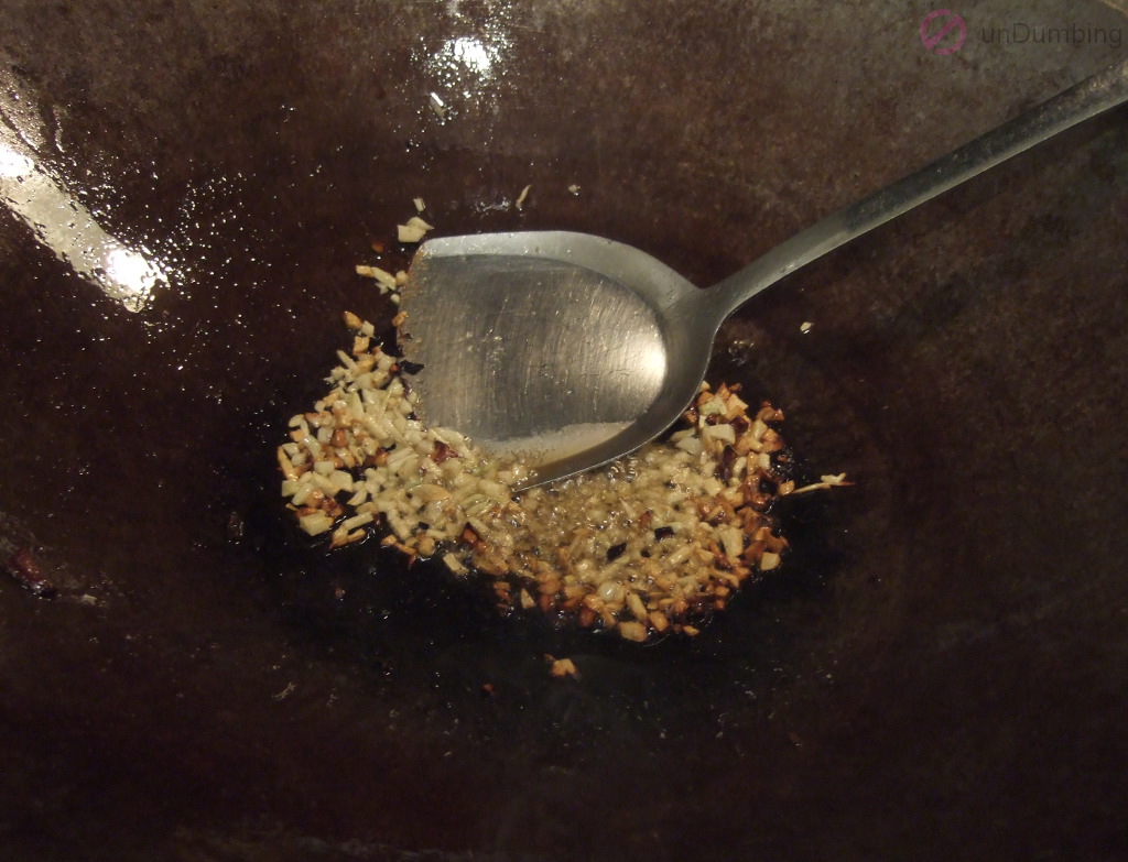 Sautéing garlic in a wok