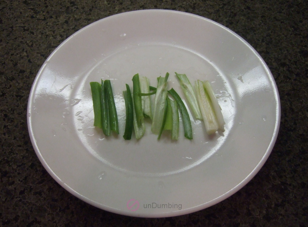 Sliced green onions on a white plate