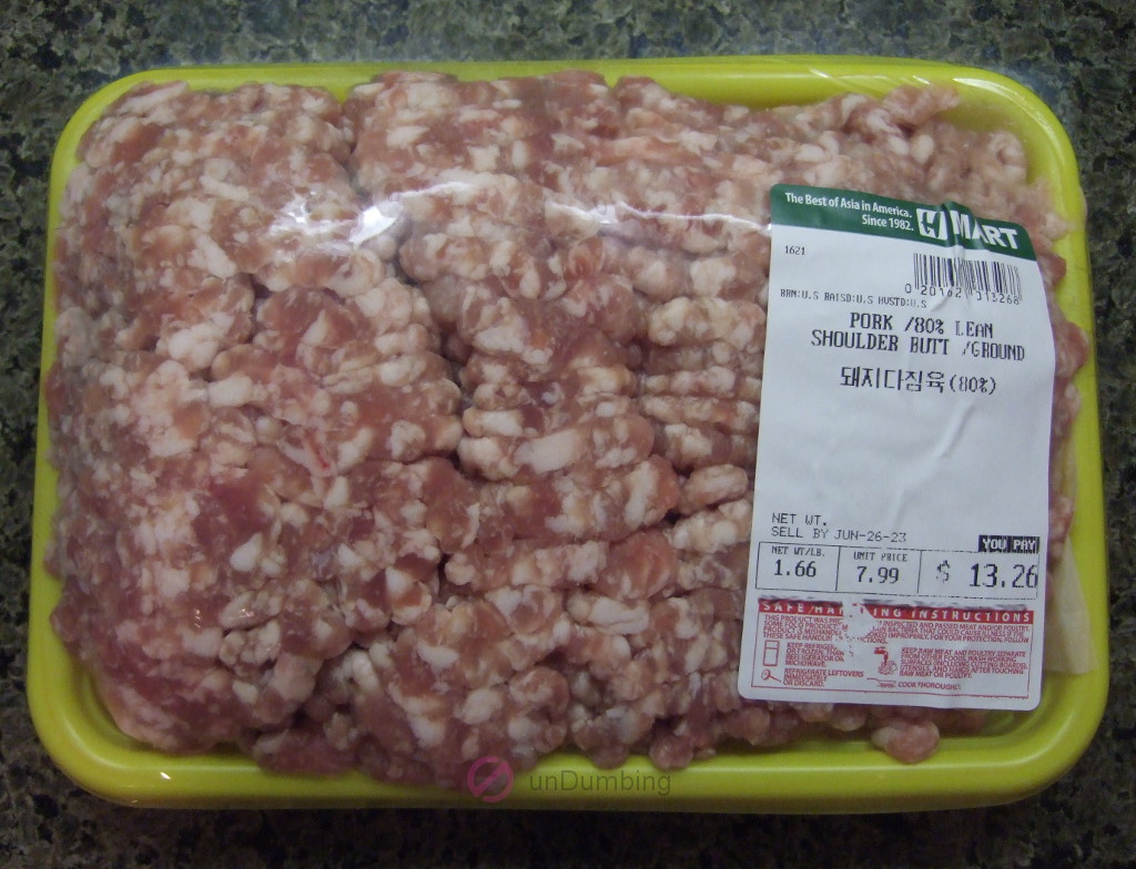 Ground pork on a clear-wrapped yellow tray