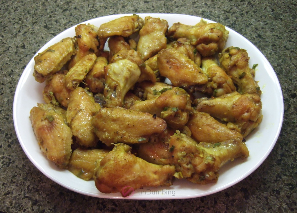 Curry-spiced chicken wings on a white plate