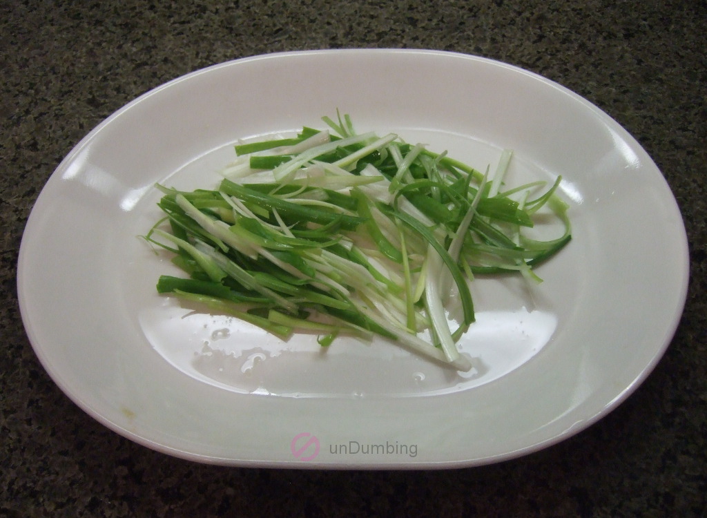 Sliced scallions on a white plate