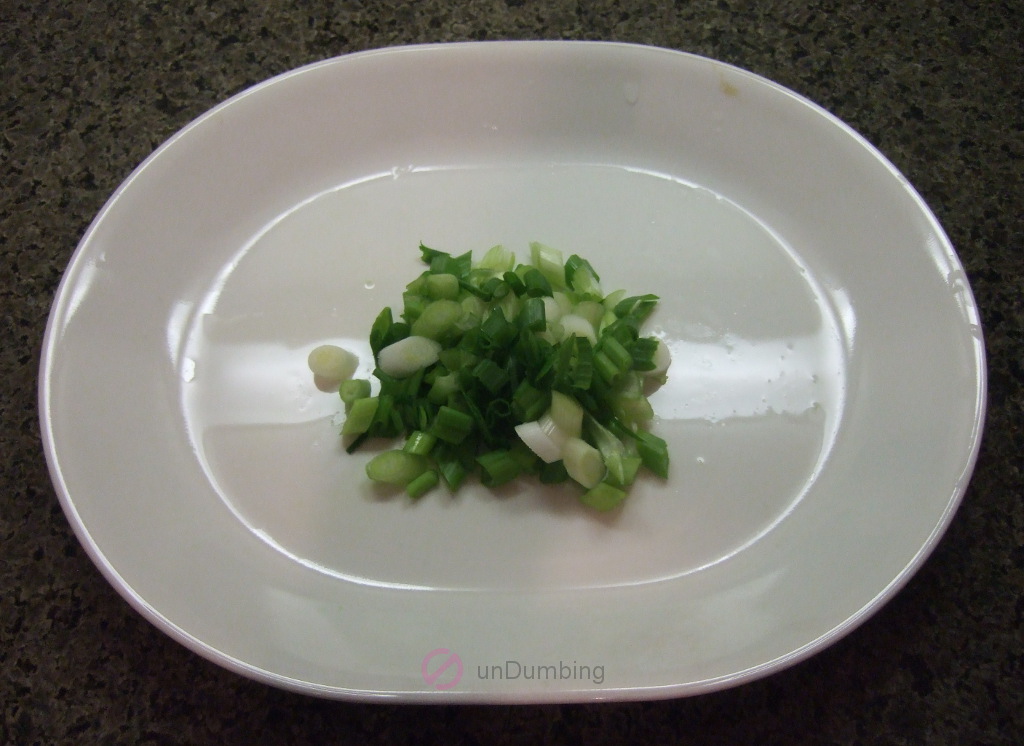 Sliced scallions on a white plate