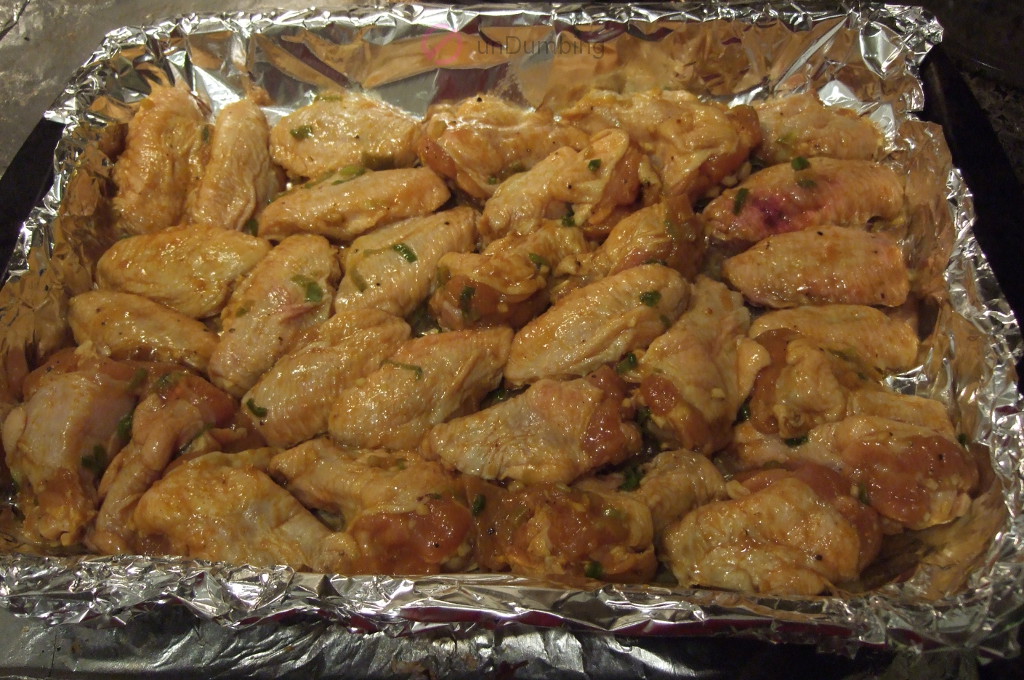 Wings on a foil-lined baking pan before baking
