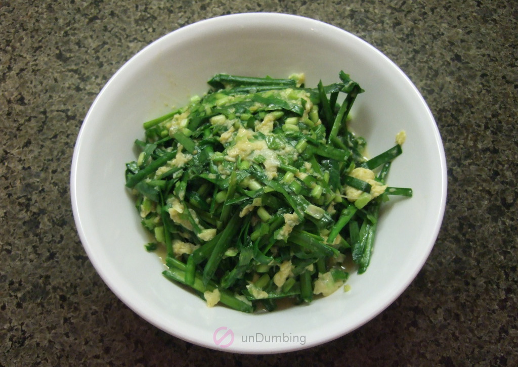 Cooked Chinese chives and eggs in a white bowl (Try 2)