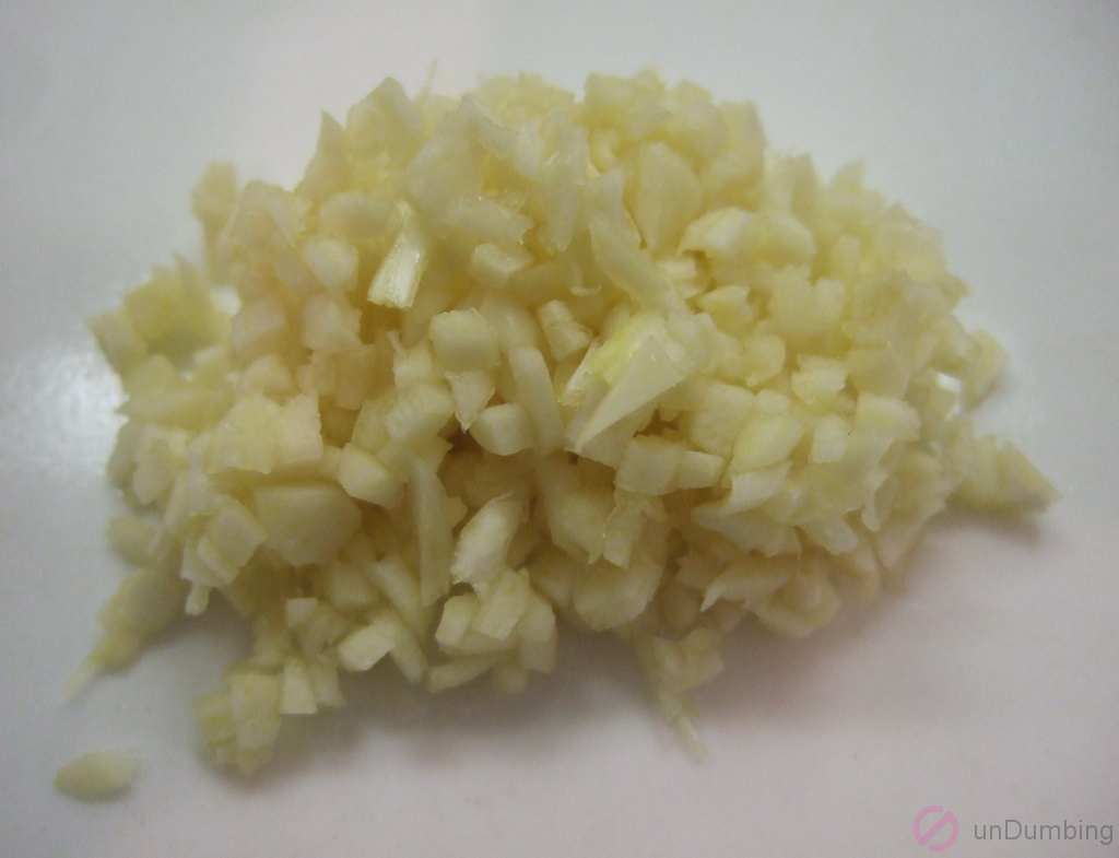 Chopped garlic cloves on a white plate