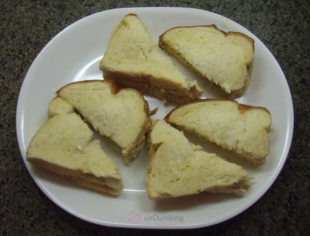 Curried egg sandwiches on a white, long plate