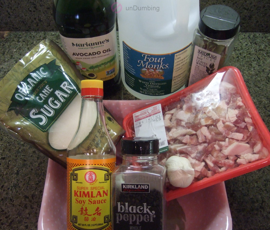 Sugar, oil, vinegar, bay leaves, pork belly, soy sauce, black peppercorns, and garlic