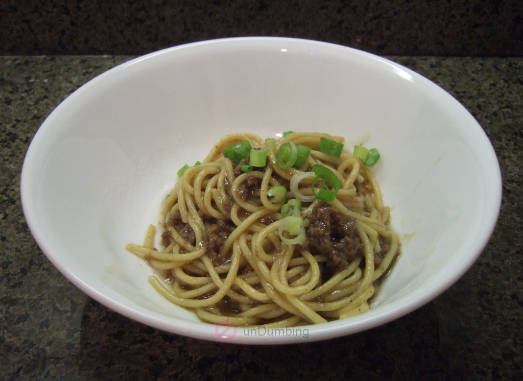 Asian ground beef noodles in a white bowl