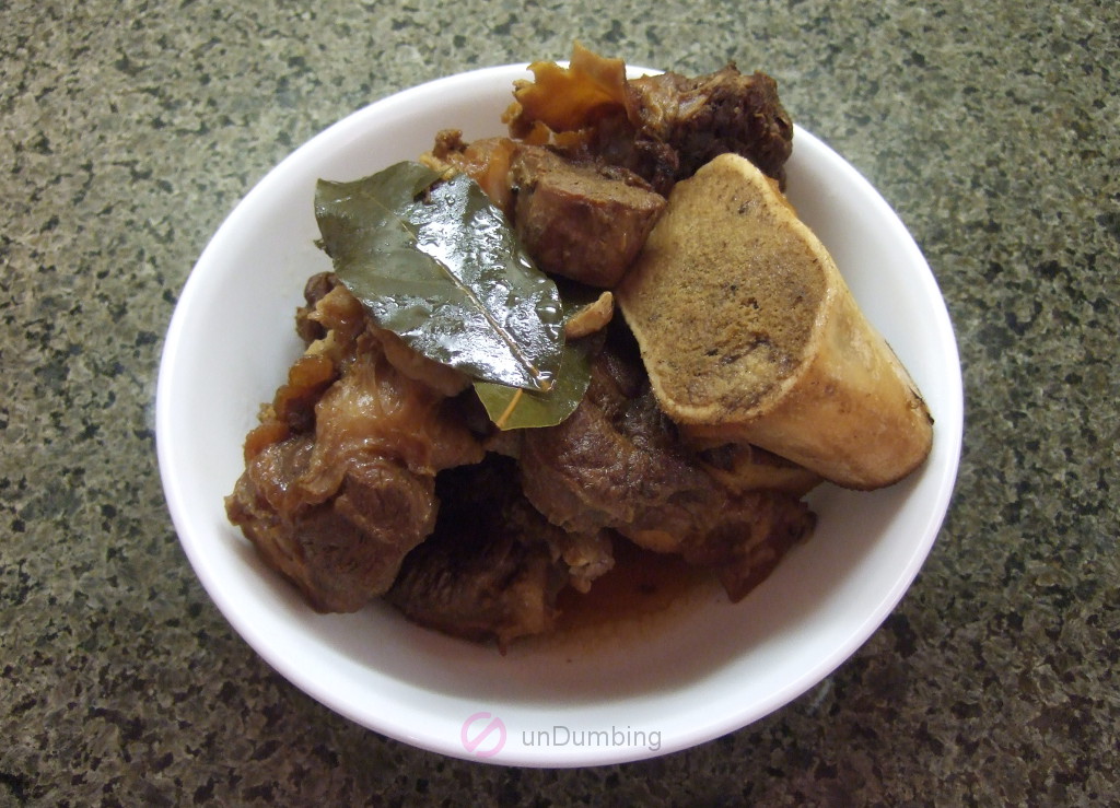 Beef shank adobo in a white bowl