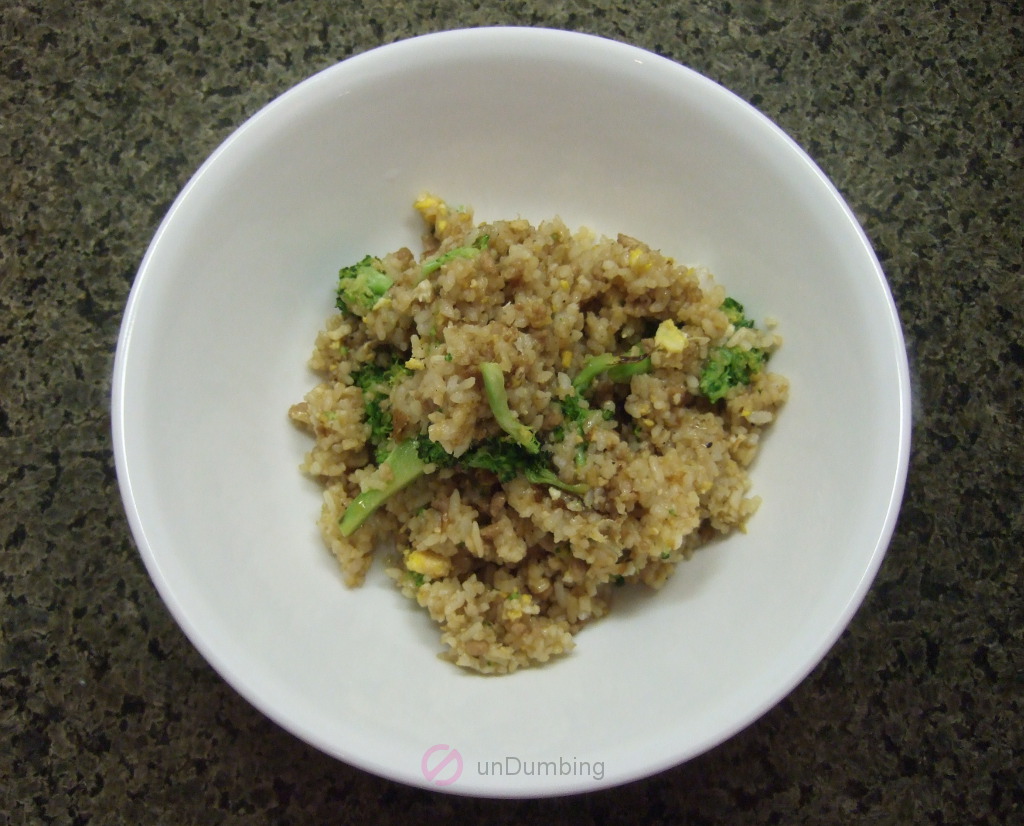 Ground pork and broccoli fried rice in a white bowl
