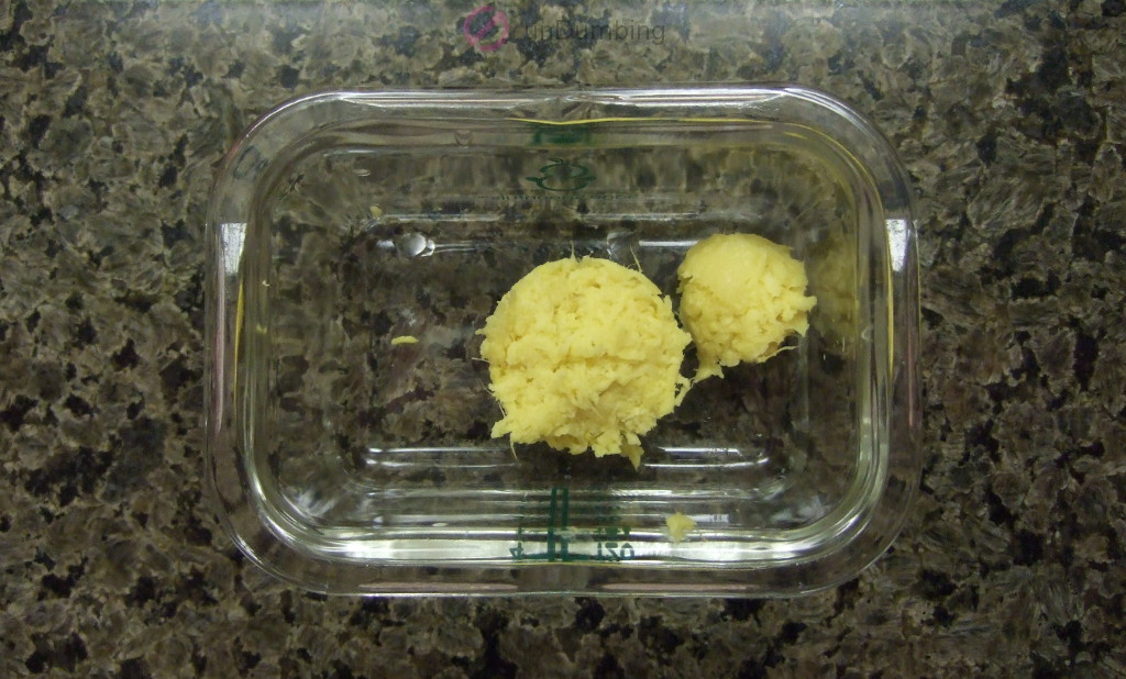 Grated ginger in a small glass food container