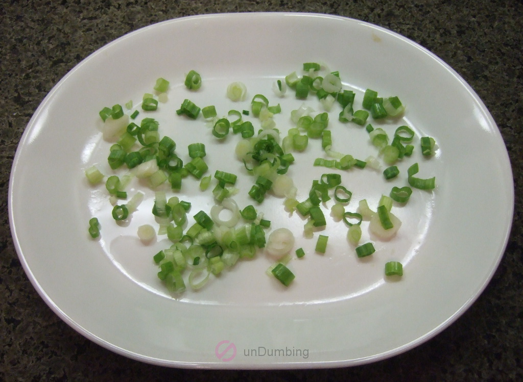 Chopped spring onion on a long white plate