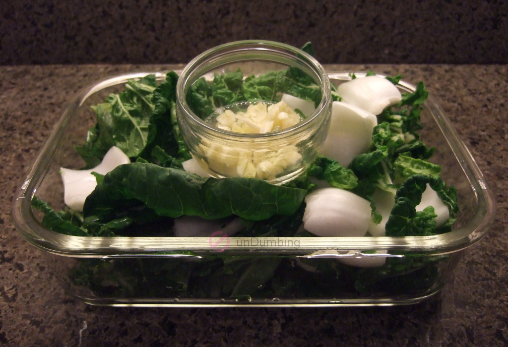 Chopped garlic and baby bok choy in glass containers