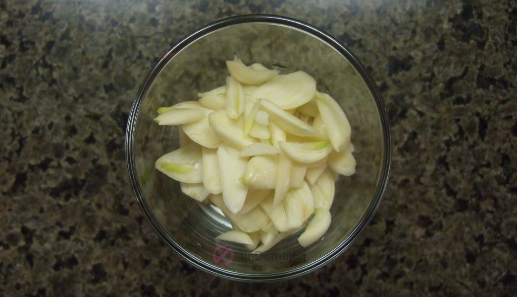 Sliced garlic in a shot glass