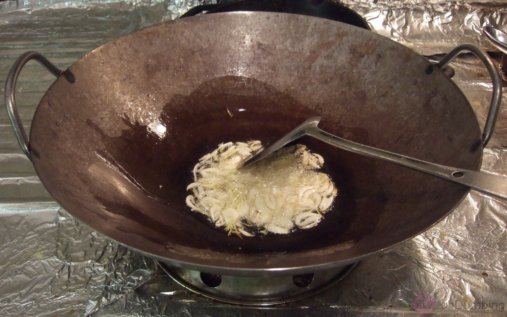Stir-frying garlic in a wok