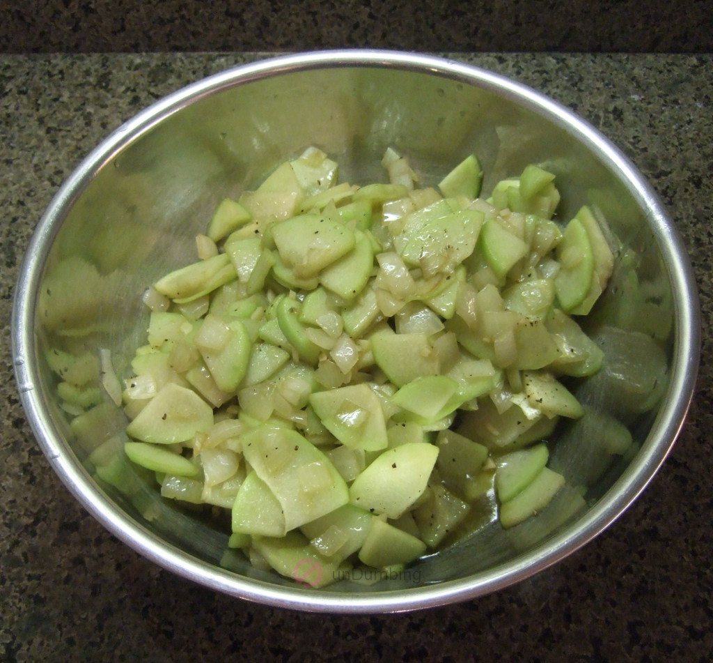 Sautéed chayote squash in a stainless bowl