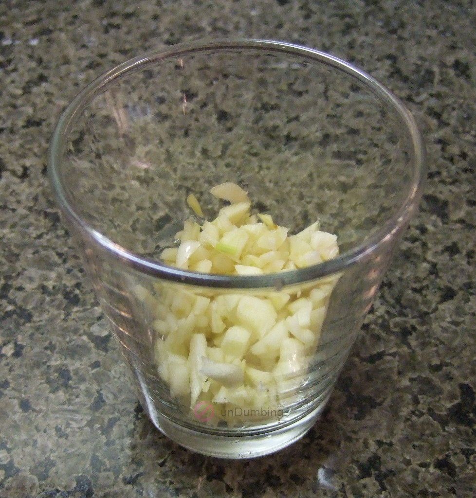 Chopped garlic in a shot glass