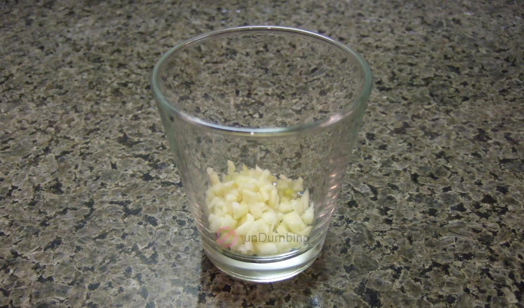 Minced garlic in a shot glass