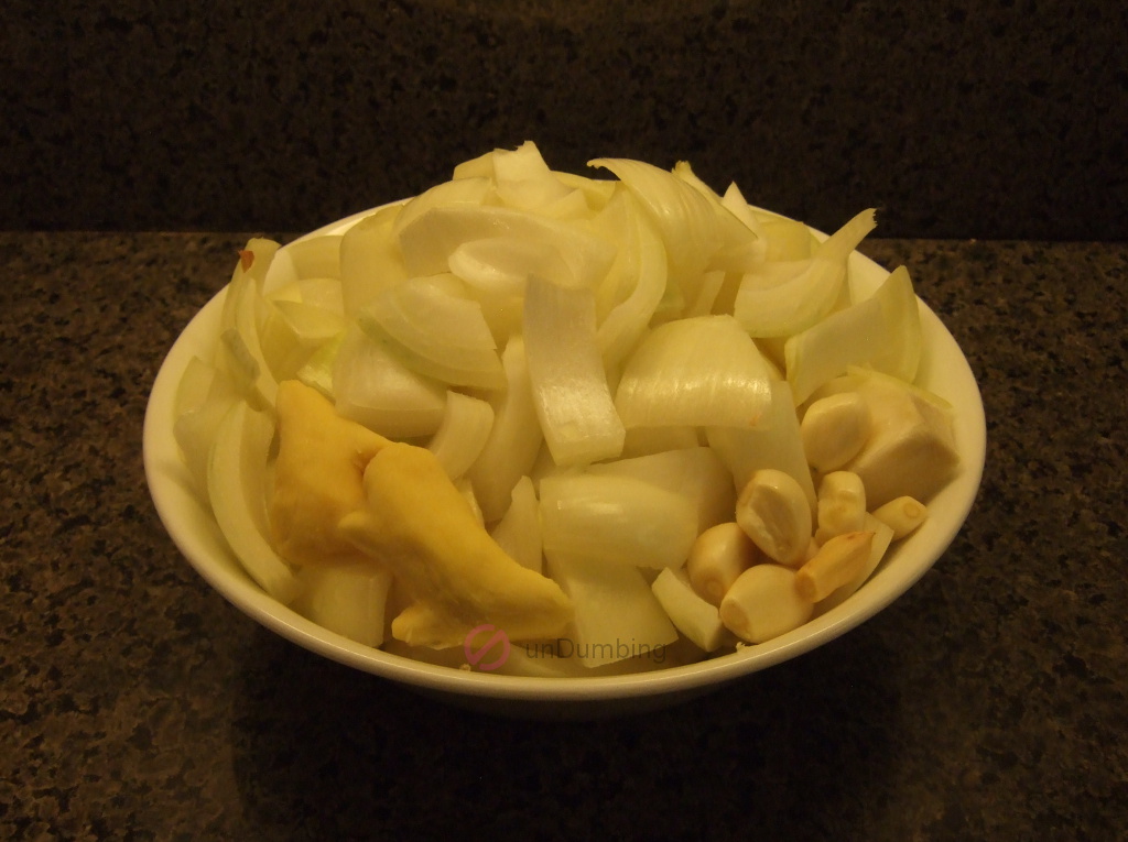 Onion, ginger, and garlic in a white bowl