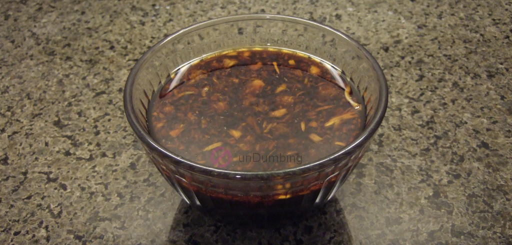 Glass bowl of sauce for braising chicken