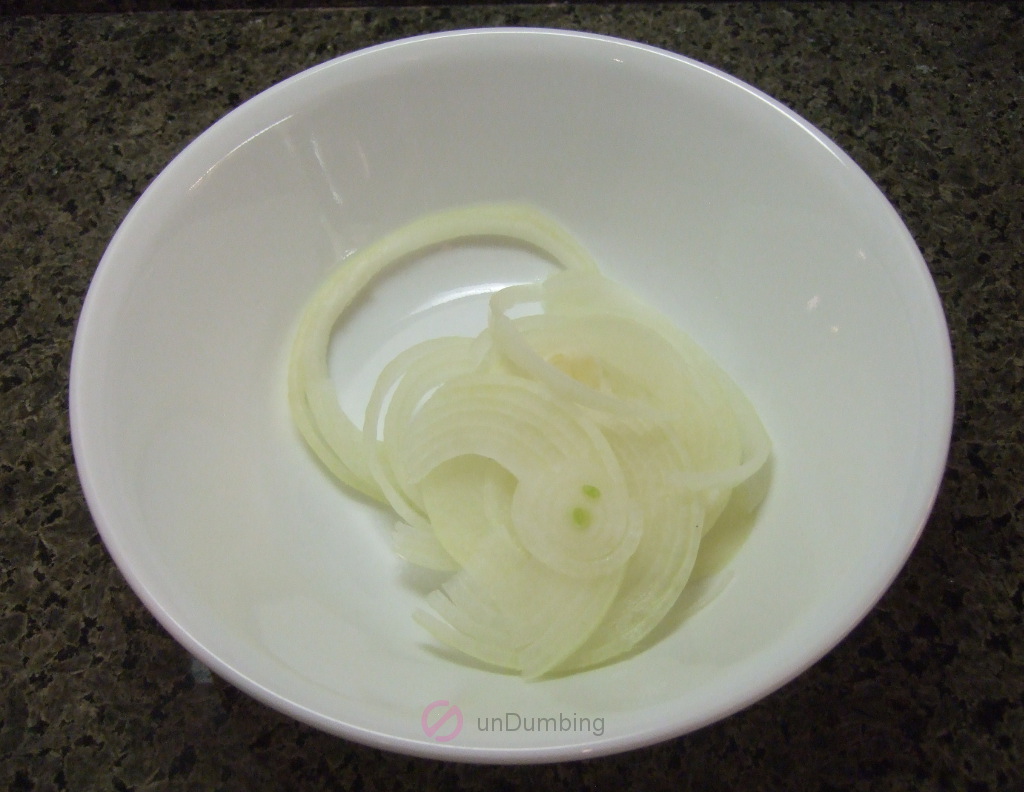 Sliced onion in a white bowl