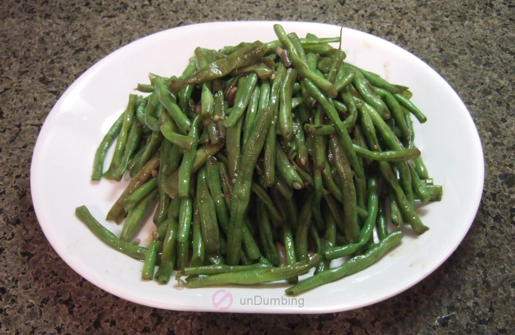 Stir-fried Chinese long beans on a white plate