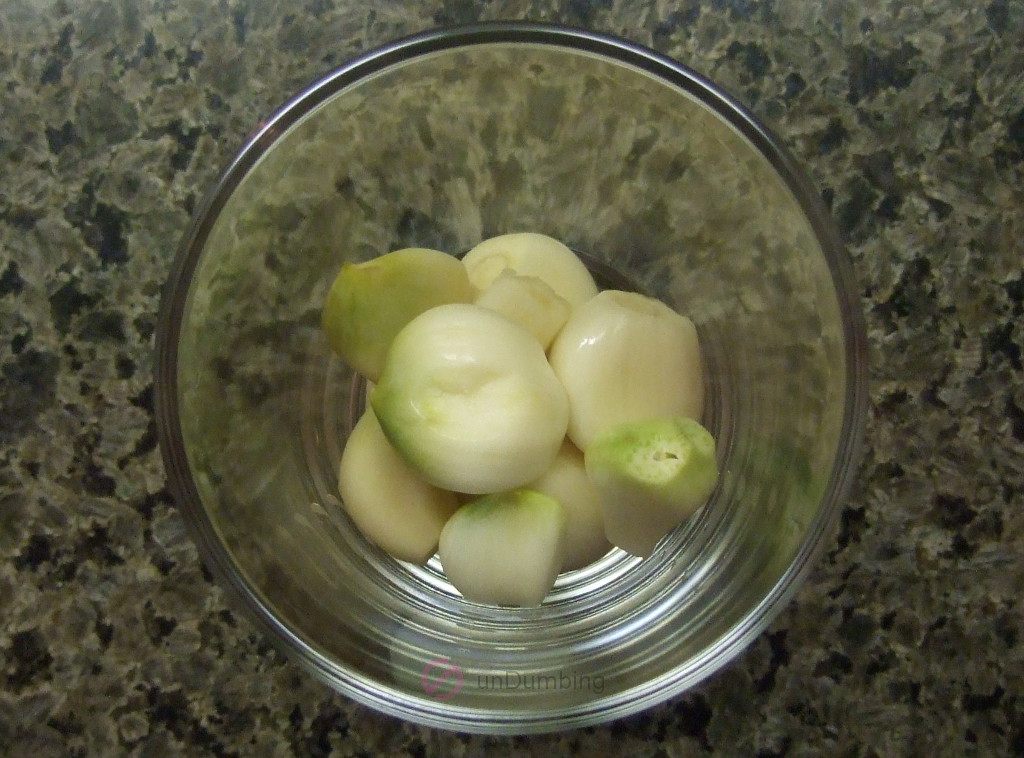 Whole garlic cloves in a shot glass