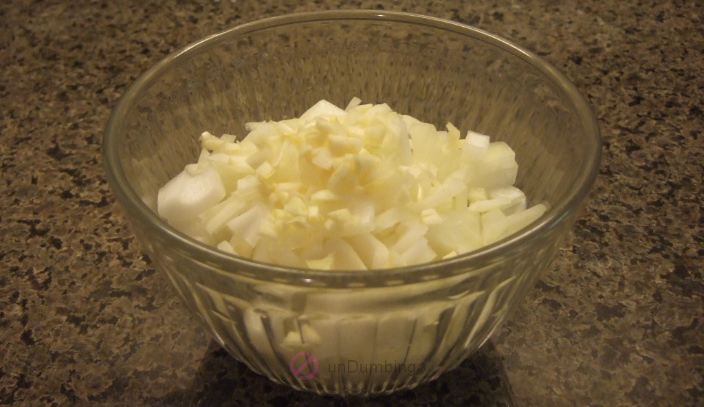 Chopped garlic and onion in a glass bowl