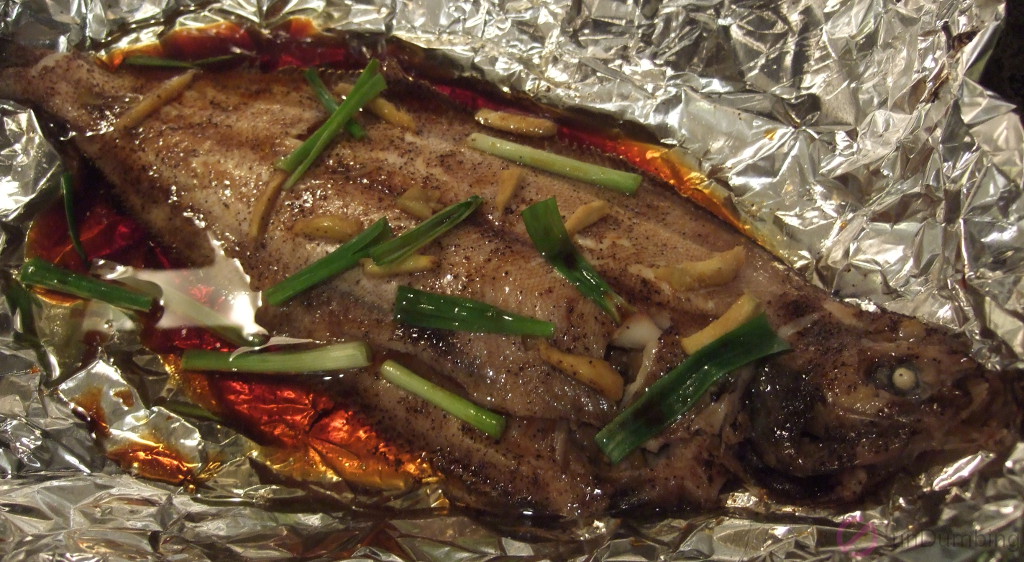 Oil and sauce added to steamed fish on a foil-lined roasting pan (Try 2)