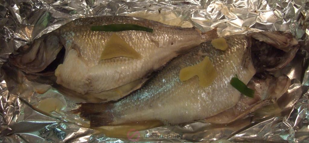 Steamed perch on foil-lined roasting pan