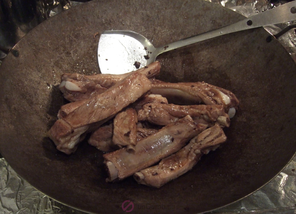 Ribs coated with sugar in a wok