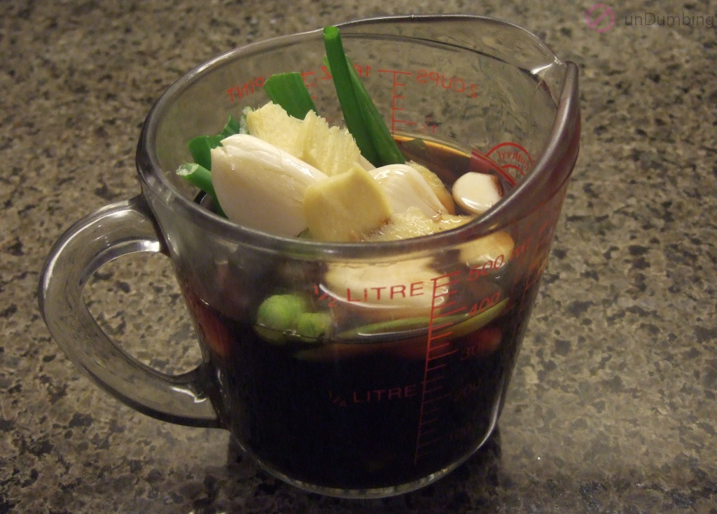 Sauce, scallion, ginger, and garlic in a measuring cup