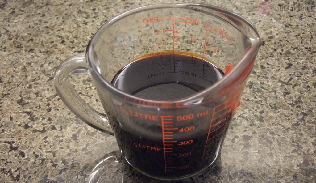 Measuring cup of soy sauce mixed with rice wine and water