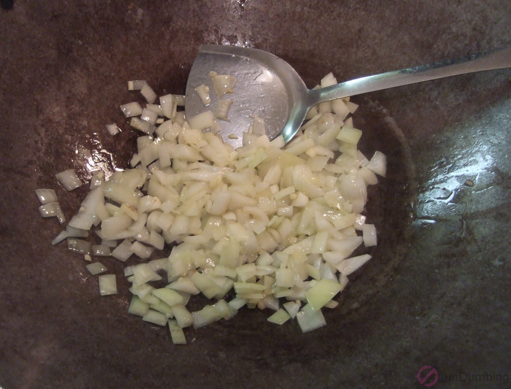 Stirring garlic and onion in a wok
