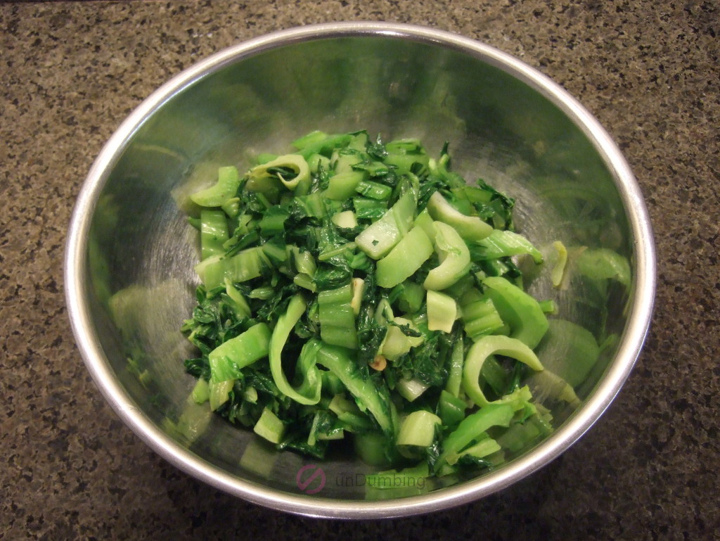 Chinese mustard greens stir-fry in a stainless steel bowl