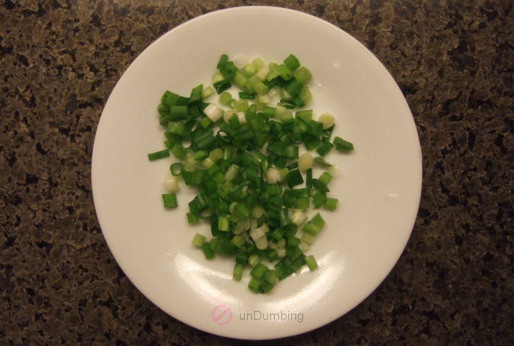 Chopped green onions on a white plate