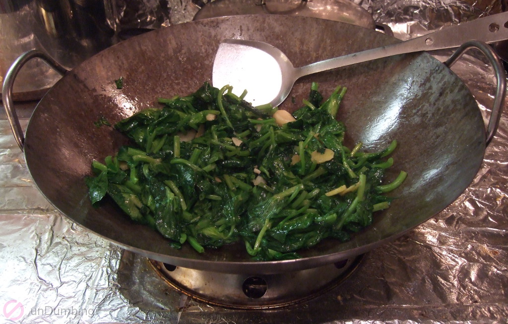 Pea shoots withering in a wok