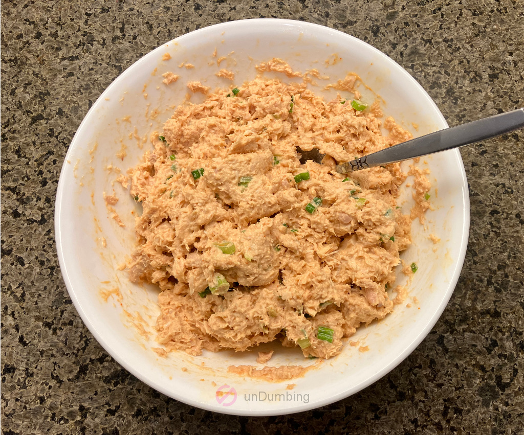 Tuna salad in a white bowl with a spoon