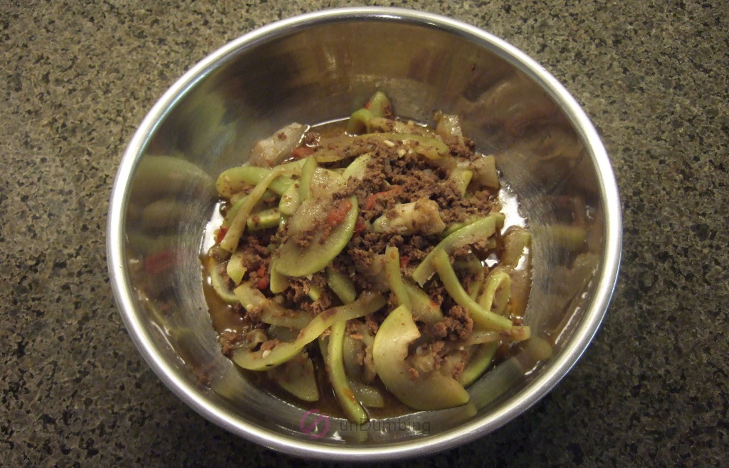 Sautéed Opo squash with ground beef in a stainless steel bowl