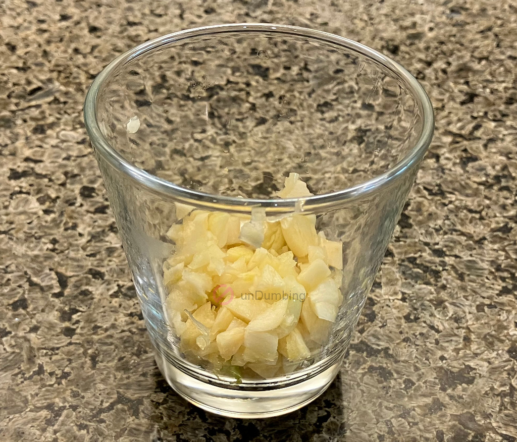 Crushed and chopped garlic in a shot glass