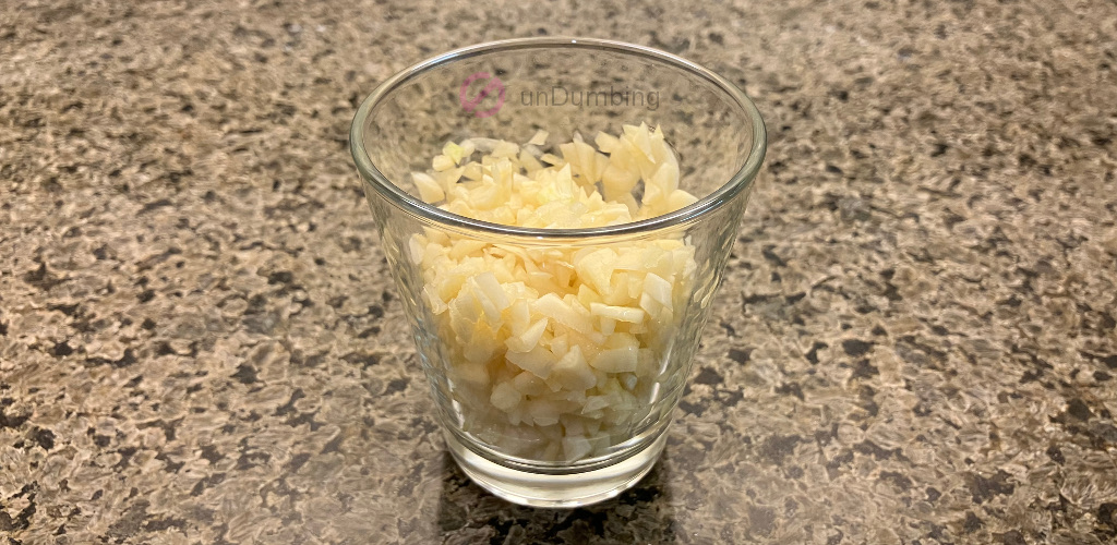 Minced garlic in a shot glass