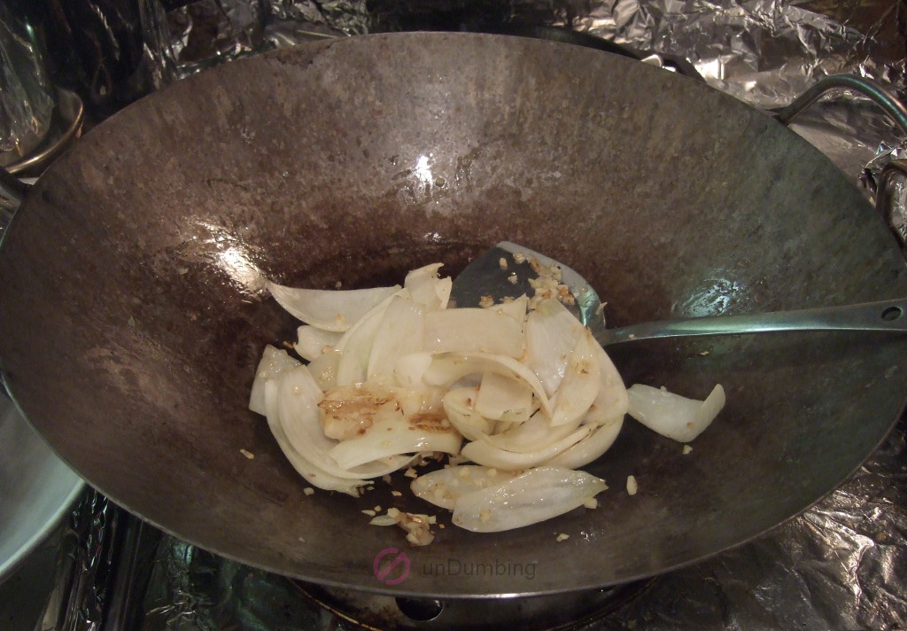 Garlic and onion caramelizing in a wok