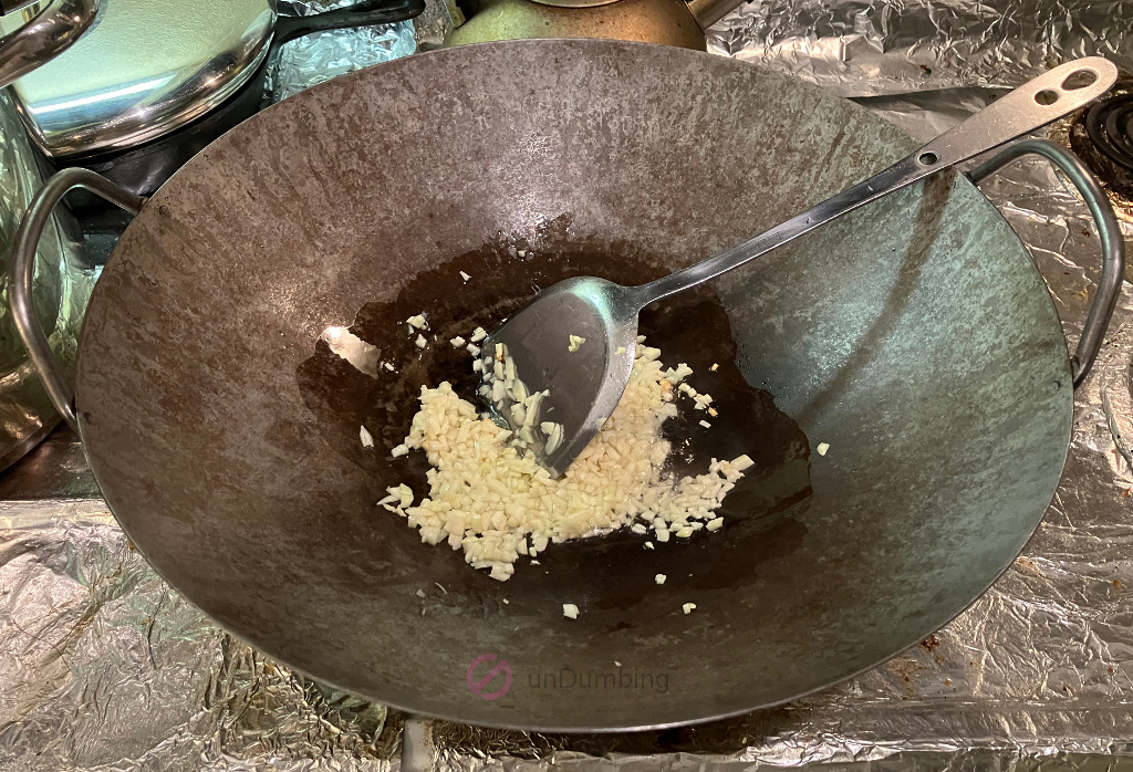 Sautéing garlic in a wok