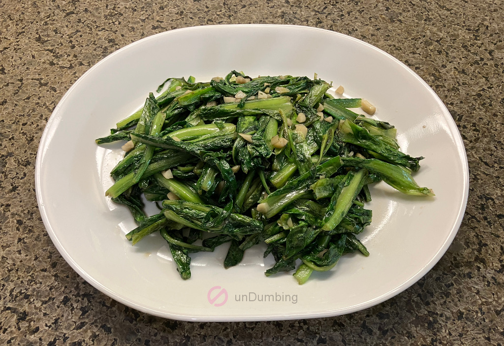 Stir-fried A Choy on a white plate (Try 2)