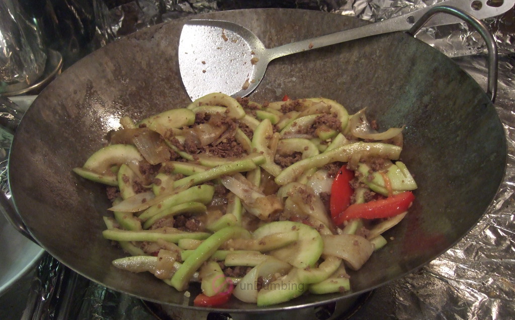 Tomato, Opo squash, and sauce added to wok for simmering