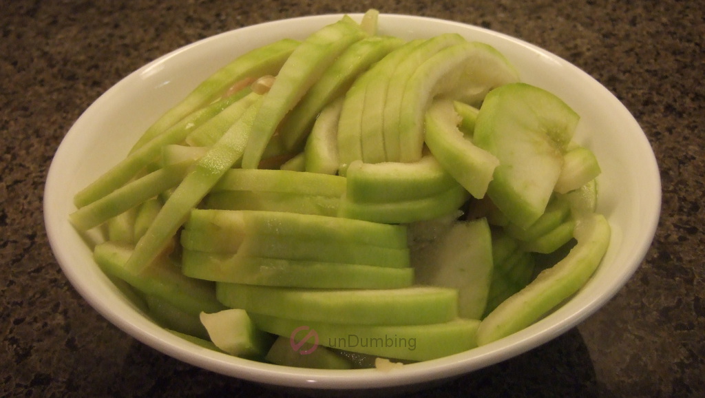 Sliced opo squash in a white bowl