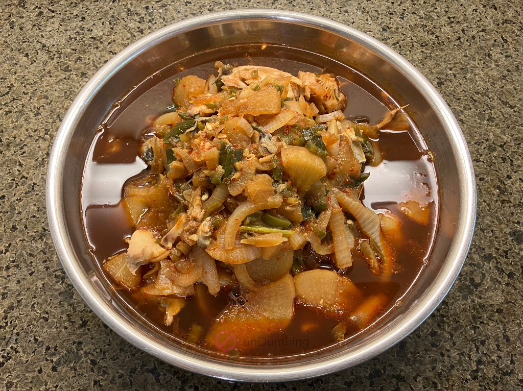 Braised black cod with radish in a stainless steel bowl