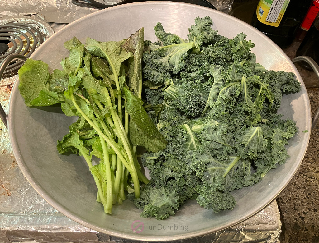 Washed and trimmed Korean mustard leaf and kale in a wok cover