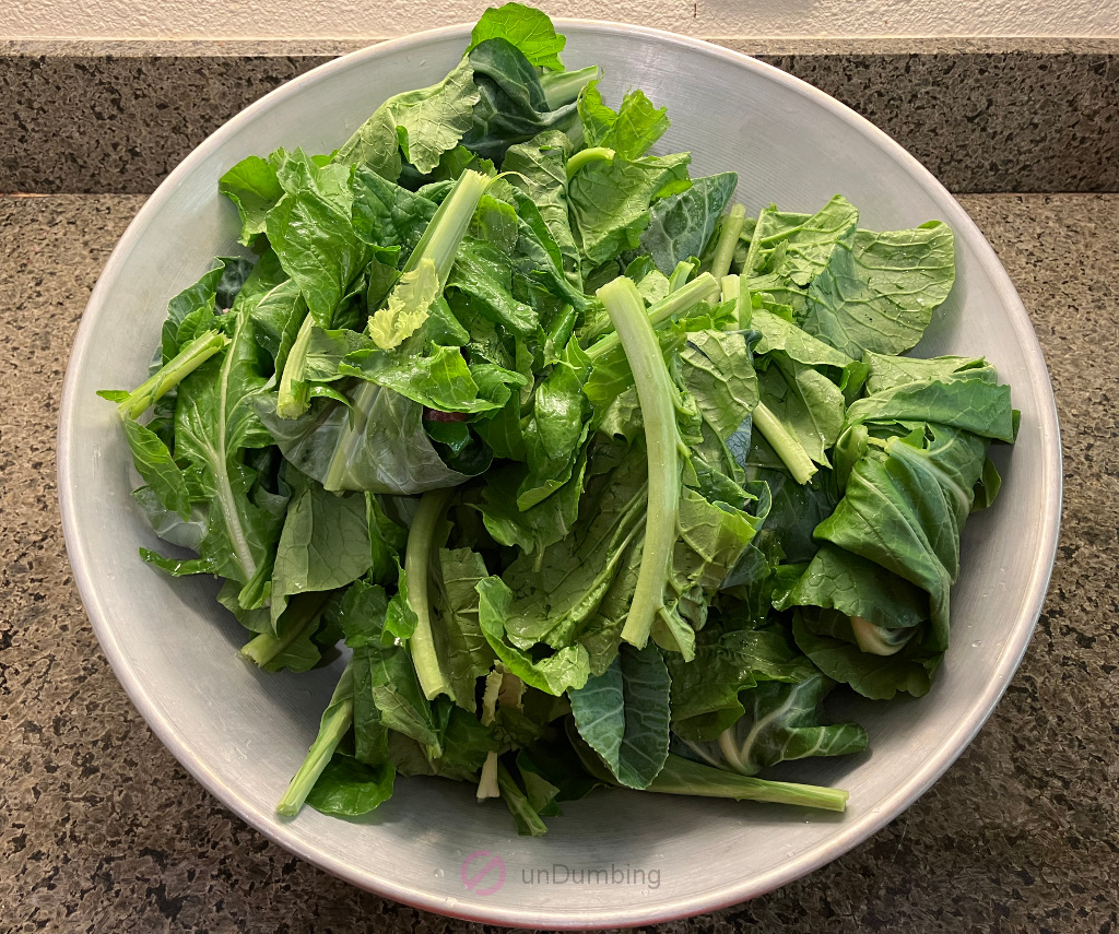 Pork wrapped in greens in a wok cover